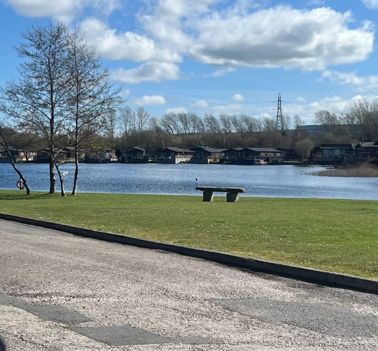 The lake at South Lakeland Leisure Village, lodges lining the far bank